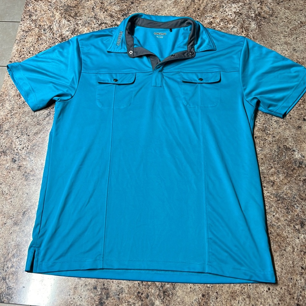 it's actually turquoise. ogio mccarthy golf shirt with bad ass pockets